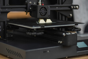 Fototapeta na wymiar close up view of 3D printer creating plastic model on blurred background
