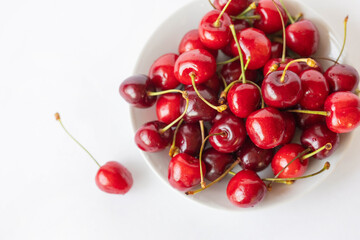 Obraz na płótnie Canvas cherries in a bowl, white background