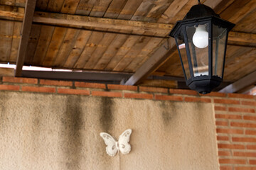 ceiling with wooden planks, lantern and butterfly ornament