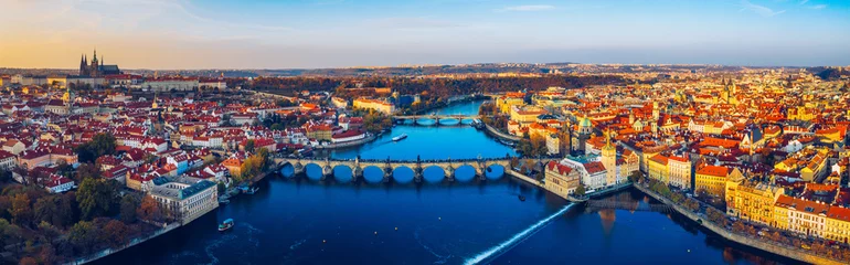 Fotobehang Aerial Prague panoramic drone view of the city of Prague at the Old Town Square, Czechia. Prague Old Town pier architecture and Charles Bridge over Vltava river in Prague at sunset, Czech Republic. © daliu