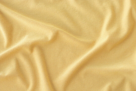 Creased yellow cloth material as a background