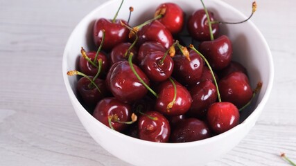 Fresh cherry on plate on wooden white background. fresh ripe cherries. sweet cherries.