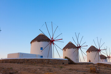 Windmills at dawn with partialy blue sky Mykonos island cyclades Greece