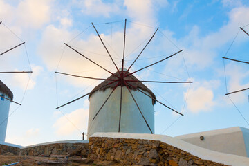 Windmills closeup with partialy blue sky and clouds Mykonos island cyclades Greece