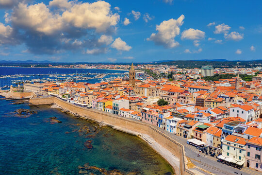Aerial view over Alghero old town, cityscape Alghero view on a beautiful day with harbor and open sea in view. Alghero, Italy. Panoramic aerial view of Alghero, Sardinia, Italy.