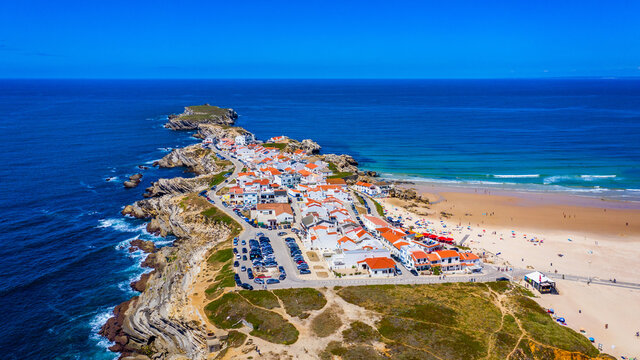 Aerial view of island Baleal naer Peniche on the shore of the ocean in west coast of Portugal. Baleal Portugal with incredible beach and surfers. Aerial view of Baleal, Portugal.