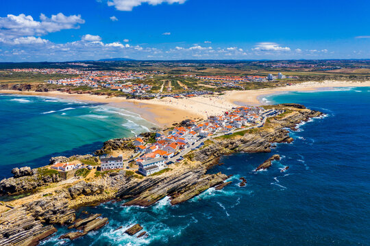 Aerial view of island Baleal naer Peniche on the shore of the ocean in west coast of Portugal. Baleal Portugal with incredible beach and surfers. Aerial view of Baleal, Portugal.