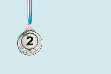 silver medal on blue background.award and victory concept.copy space