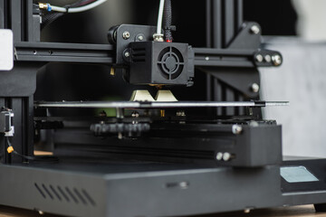 Fototapeta na wymiar close up view of 3D printer creating plastic model on blurred background