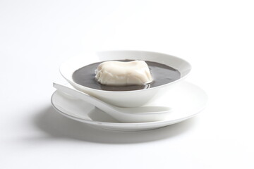 chef cook thick black sesame sweet soup with soya milk pudding jelly in white bowl Chinese...