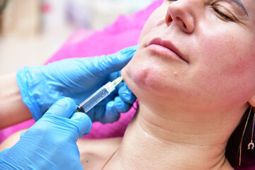 Beautician makes beauty injections. Anti-aging facial skin care, anti-wrinkle and sagging skin. 