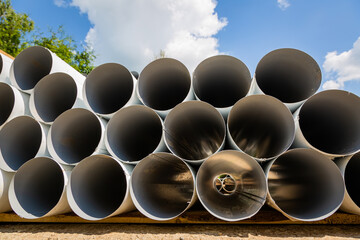 Downpipe warehouse. Steel pipes, parts for the construction of a roof drainage system in a...