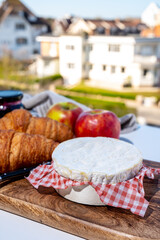 French breakfast with fresh baked croissants and cheeses from Normandy, camembert and neufchatel served outdoor with nice city view