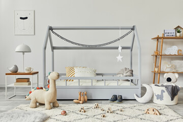 Stylish scandinavian child's room with creative wooden bed, coffee table, lamp, wooden shelf, plush...