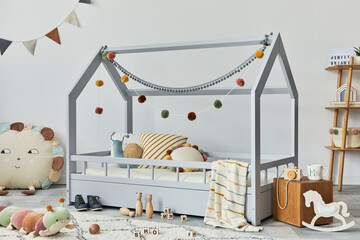 Stylish scandinavian child's room with creative wooden bed, wooden cube, plush and wooden toys and...