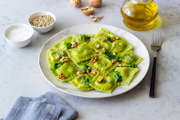 Green ravioli with ricotta cheese, spinach and nuts. Healthy eating. Vegetarian food. Italian cuisine.