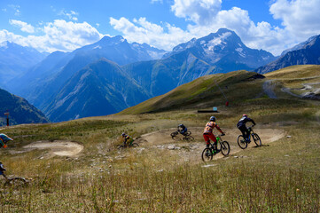 Fototapeta na wymiar Extreem outdoor sport challenge in French Alps mountains in summer, riding downhill on sport bike on special bicycle path