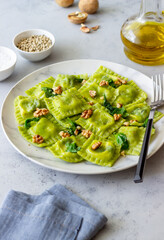 Green ravioli with ricotta cheese, spinach and nuts. Healthy eating. Vegetarian food. Italian cuisine.