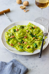 Green ravioli with ricotta cheese, spinach and nuts. Healthy eating. Vegetarian food. Italian cuisine.