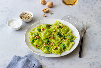 Green ravioli with ricotta cheese, spinach and nuts. Healthy eating. Vegetarian food. Italian cuisine.