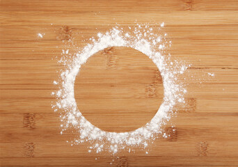 Round flour frame on a wooden bamboo background