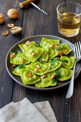 Green ravioli with ricotta cheese, spinach and nuts. Healthy eating. Vegetarian food. Italian cuisine.