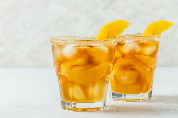 Tropical orange iced tea, summer party drink in glasses. Space for text.