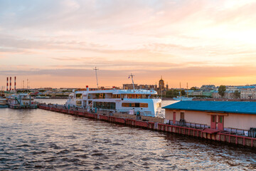 Fototapeta na wymiar The pier on the river in St. Petersburg at sunset. Beautiful panorama. Saint Petersburg, Russia - 05 June 2021