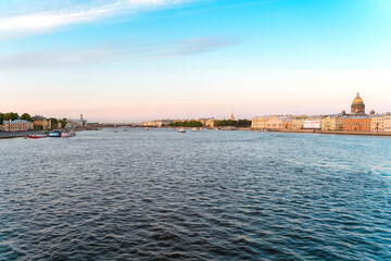 Summer panorama of the city and the river in St. Petersburg. Postcard view and the concept of river tourism at sunset