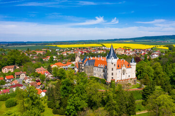 Aerial view of Zleby castle in Central Bohemian region, Czech Republic. The original Zleby castle was rebuilt in Neo-Gothic style of the chateau. Chateau Zleby, Czechia.