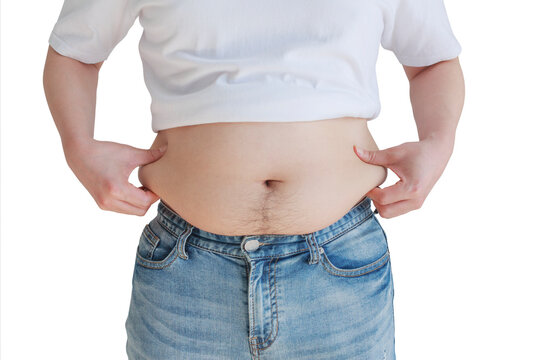 A man in jeans is pulling his belly fat.