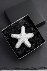 Seed bead embroidered brooch in a shape of starfish