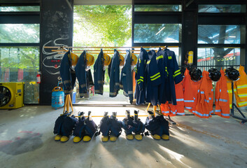 Firefighting or fireman clothes on rack at fire station storage, an emergency accident rescue...