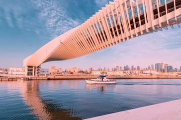 Foto op Plexiglas Helix Bridge A masterpiece of modern design in architecture - the spiral pedestrian bridge over the water channel in Dubai, UAE tourist attractions