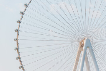 Close-up details of the Ferris wheel with metal beam guides and passenger booths. Dubai Eye on...