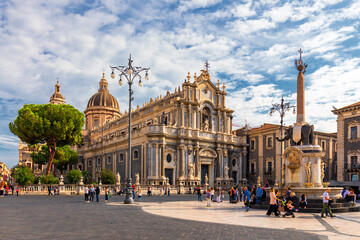 Piazza del Duomo in Catania on a summer day, with Duomo of Saint Agatha and the Elephant Fountain. Sicily, southern Italy. View of Cathedral Sant Agata on Piazza del Duomo in Catania, Sicily, Italy. - obrazy, fototapety, plakaty