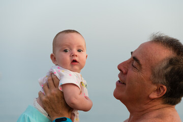 A little baby and her grandfather