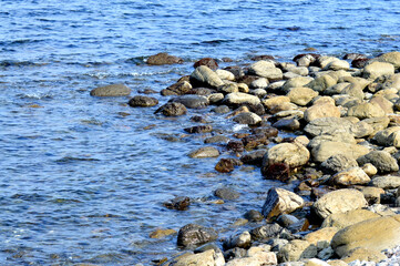 Beautiful romantic photo, seashore on the beach. Relaxing seascape. Waves with foam on the sea. Summer sunny day. Vacation spirit. Beautiful landscape. Nature background