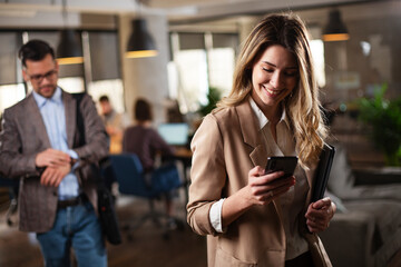 Businesswoman in office. Smiling businesswoman using the phone