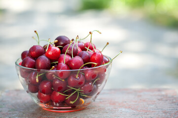 Ripe red cherries in a cup. Summer background 