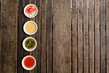 Flavoring food on wooden background at restaurant.