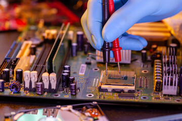 nstalling computer processor to motherboard. concept-repair of PCB. Hand with PCB on a blurred background.