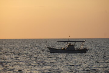 Beautiful sunset with fishing boat
