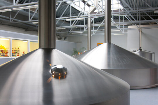 Interior of brewery, large steel storage tanks for brewing beer. 