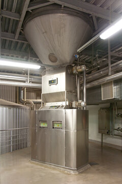 Interior of brewery, hopper and metal beer mashing tanks