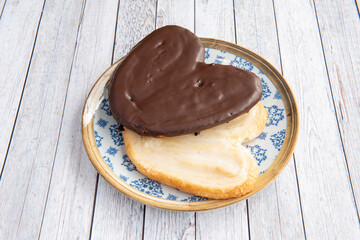 two seductive palms of plain and white chocolate and milk chocolate on wooden table