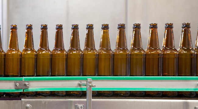 Beer bottling plant, rows of bottles, automated process