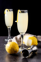 French 75 cocktail in glass on black background