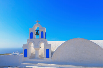 Greece Santorini island in Cyclades, traditional view of white washed houses with colorful wooden...