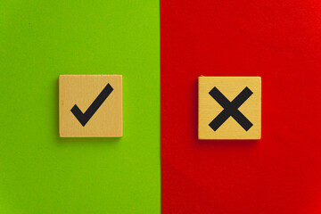 True or false,Good or Bad,Okay or cancel,Accept or deny synbols on wooden cube over green and red background with copyspace